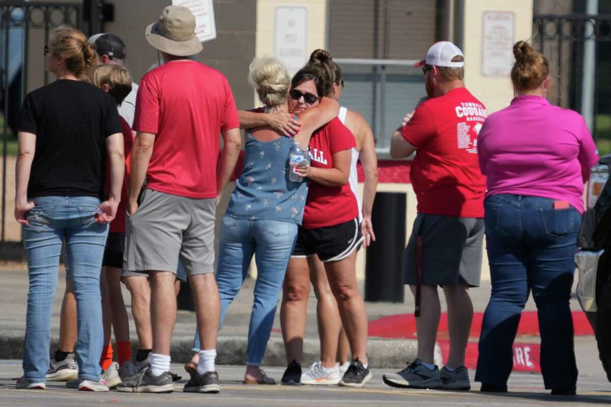 People gather Friday for a community vigil Tomball High School for the five Collins family members killed by an escaped prisonerin Centerville.