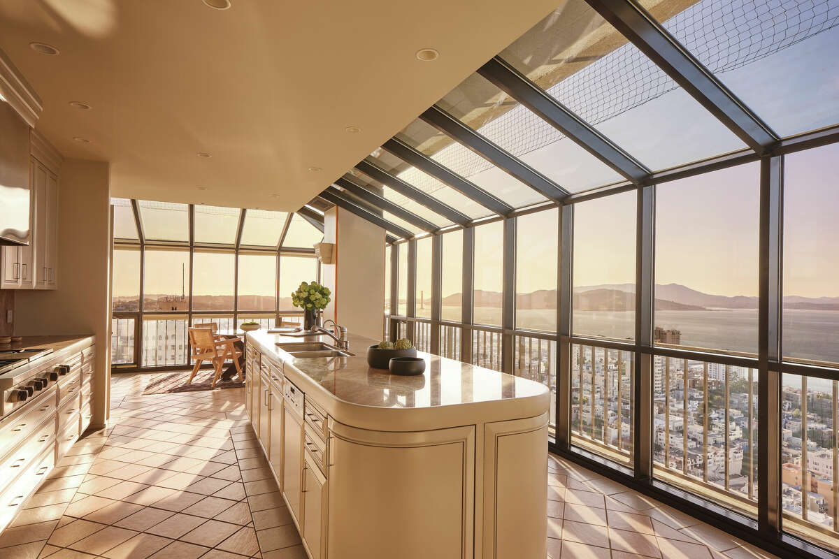 A large, well-equipped kitchen in the north penthouse looks out over the city, the bay and mountains. 