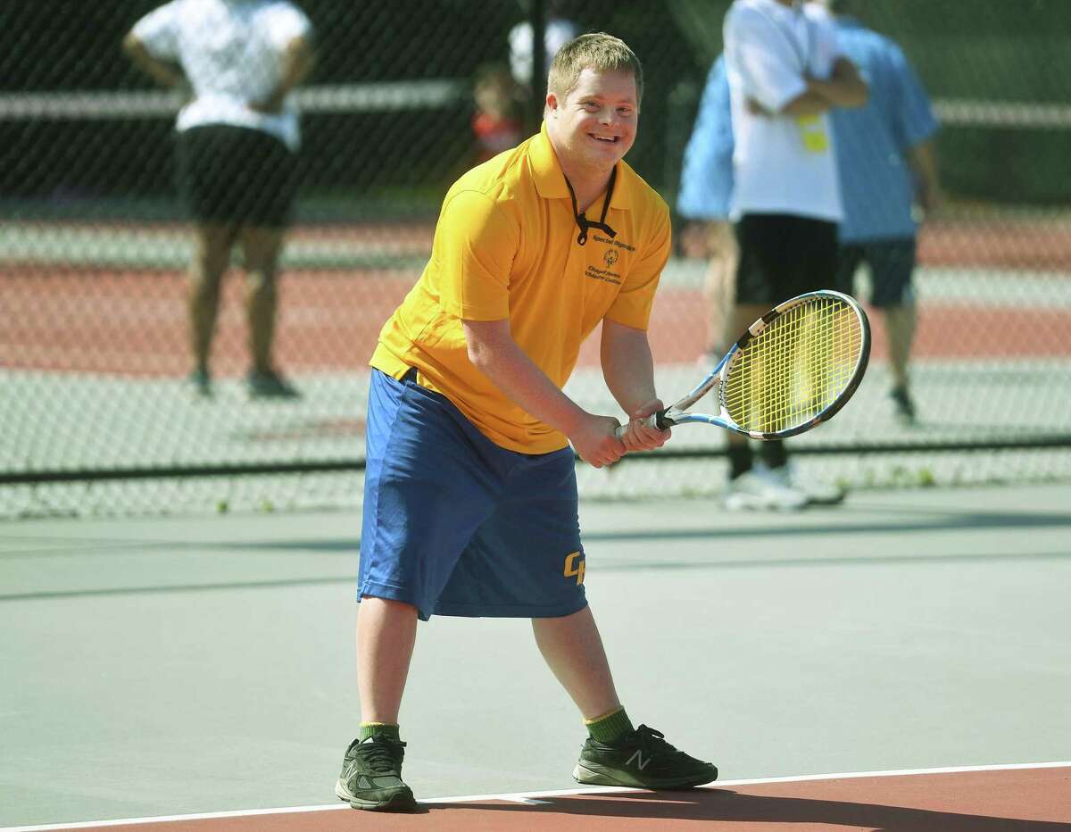 Sam Powell, of New Haven, competes with a big smile in Connecticut Special Olympics tennis at Fairfield University in Fairfield, Conn. on Saturday, June 4, 2022.