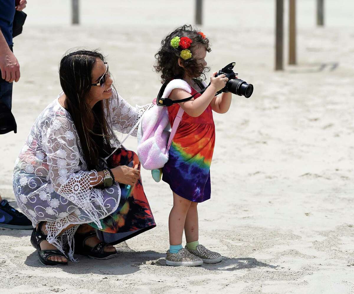 Athena Guajardo, 3, takes photos of her mom, Jennifer Guajardo’s painted barrel as Artist Boat and Odyssey Academy hosted a “Beauty the Bucket” competition during the World Ocean Day Festival on the East Beach on Saturday, June 4, 2022 in Galveston. The theme for World Ocean Day was focused on restoring the vibrancy and balance in the Ocean. After the competition, the barrels will be added to Galveston Beaches where they will be used and viewed by visitors, and encourage proper disposal of trash to reduce aquatic trash.