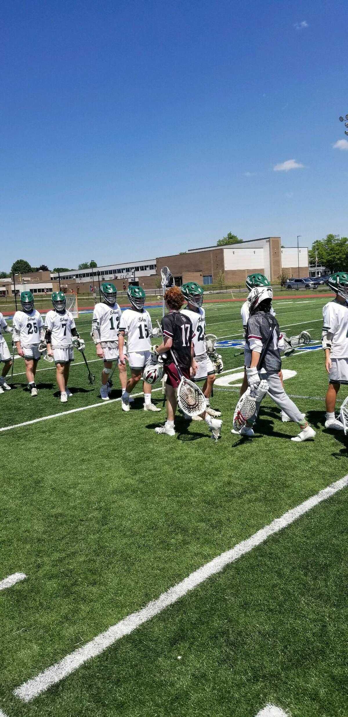 Shenendehowa and Scarsdale players shake hands after Scarsdale's victory in the Class A state quarterfinals at Shaker High School on Saturday, June 4, 2022.