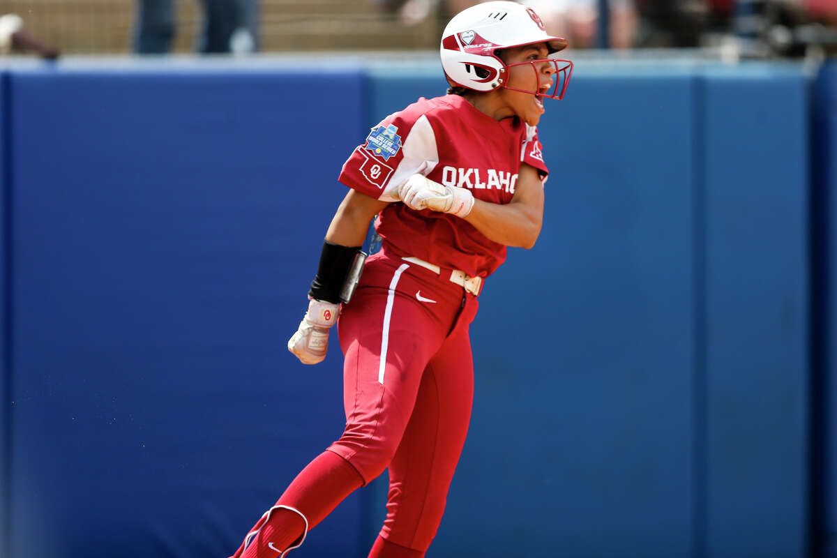 Oklahoma outfielder Rylie Boone (0) yells after scoring a run during an NCAA softball Women's College World Series game against Texas Saturday, June 4, 2022, in Oklahoma City. (Ian Maule/Tulsa World via AP)
