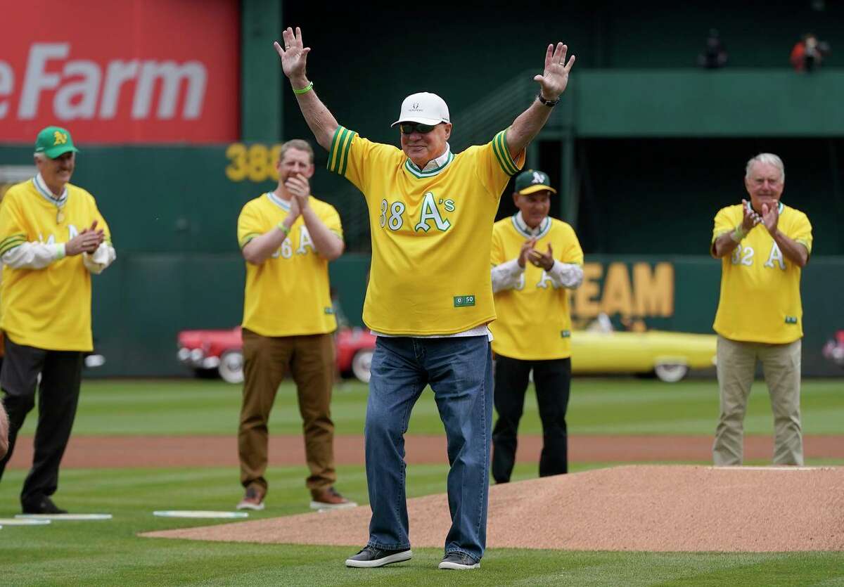 Gene Tenace waves after throwing the ceremonial first pitch during a celebration of the Oakland Athletics' 1972 World Series winning team before a baseball game between the Athletics and the Boston Red Sox in Oakland, Calif., Saturday, June 4, 2022. (AP Photo/Jeff Chiu)