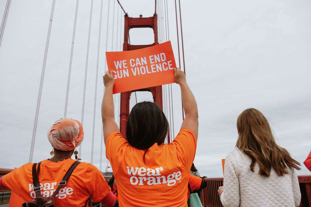 Marchers participate in a Wear Orange walk across the Golden Gate Bridge for National Gun Violence Awareness Day.