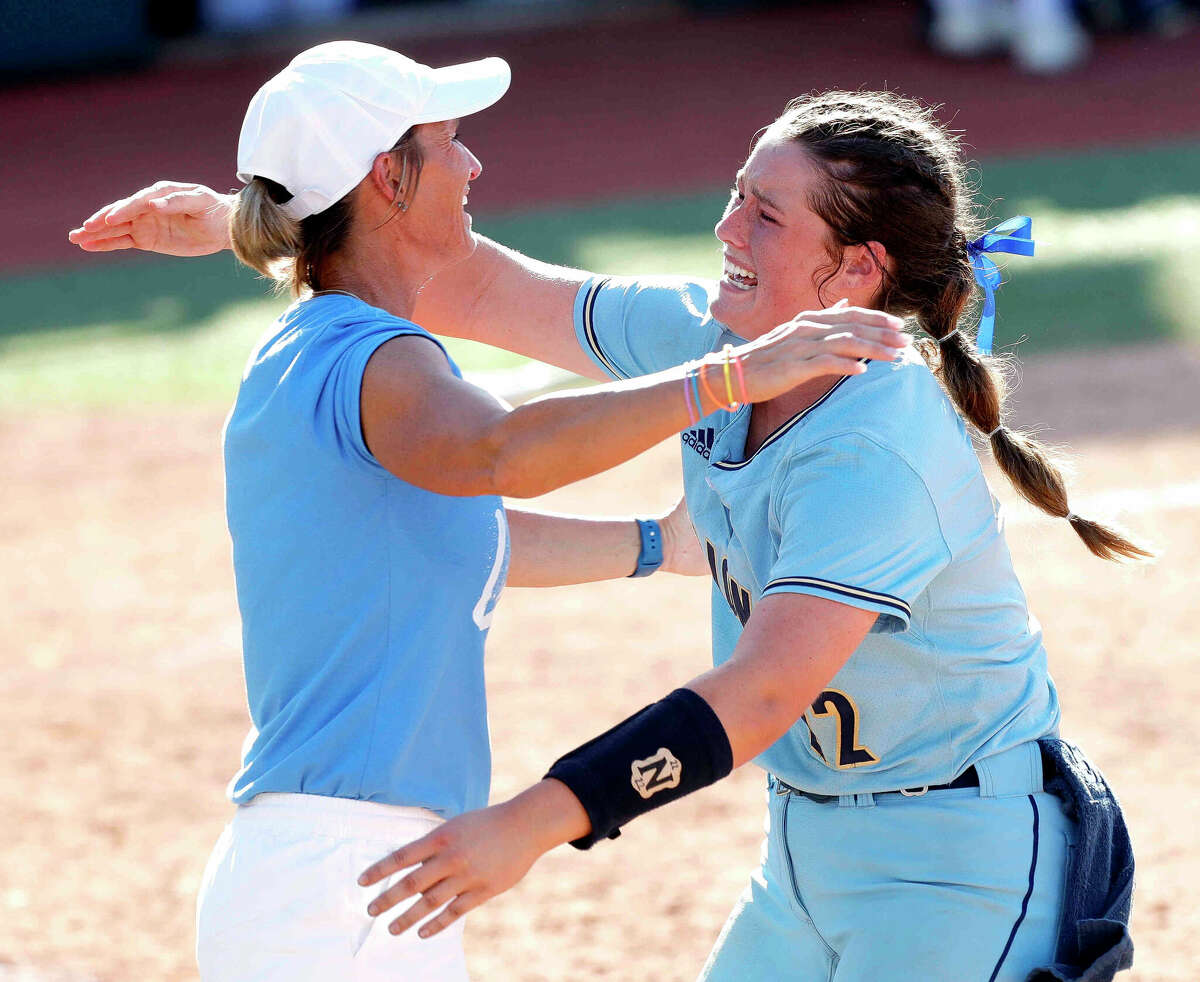 Lake Creek starting pitcher Ava Brown runs up to hug head coach Michelle Rochinski after shutting out Georgetown 7-0 to win the Class 5A championship during the UIL State Softball Championships at Red & Charline McCombs Field, Saturday, June 4, 2022, Austin.