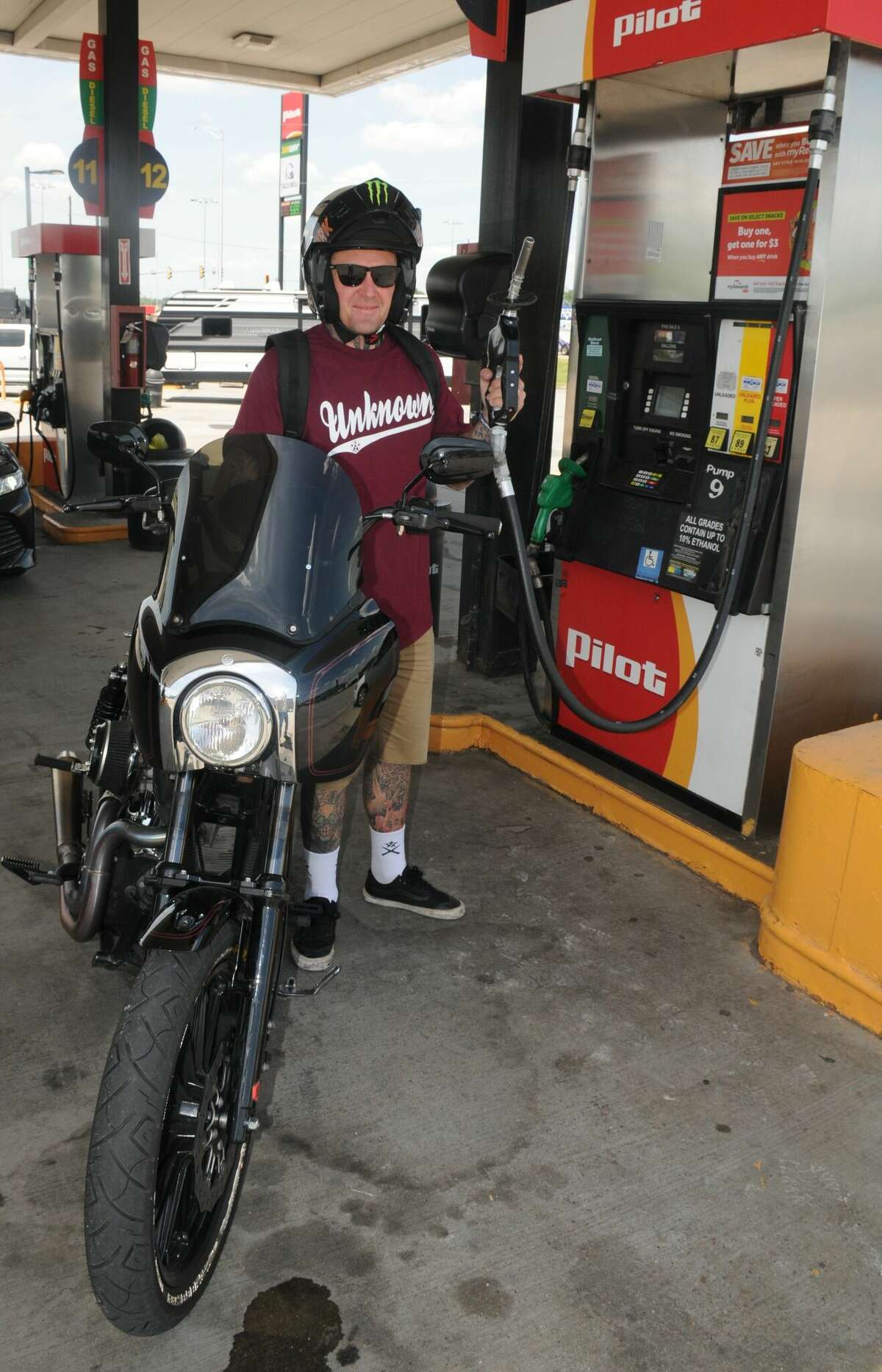 Buddy Suttle of California, who does motorcycle stunt riding at NASCAR events, gases up Saturday at the Pilot Travel Center across the road from the World Wide Technology Raceway.
