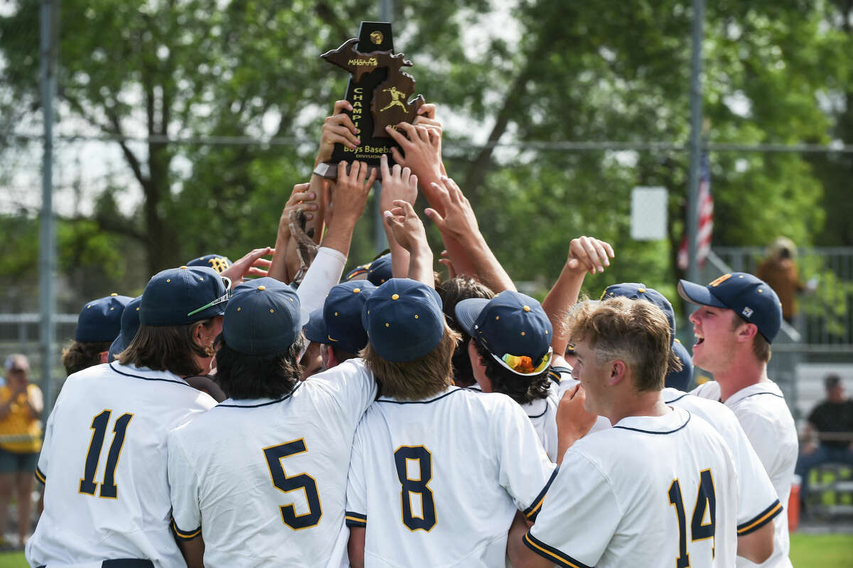 Midland celebrates a district championship after the District finals game between Midland High and Bay City Western on Saturday, June 4, 2022 at Heritage High School.