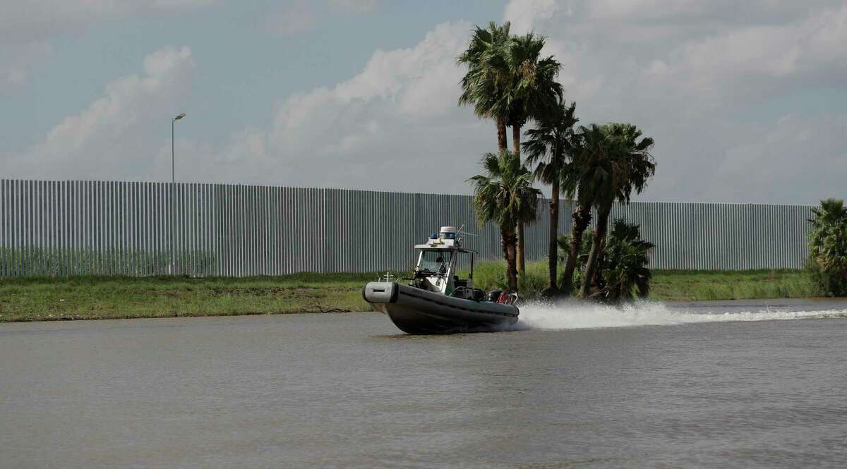 U.S. Customs and Border Patrol boat moves along the Fisher border wall, a privately funded border fence, along the Rio Grande River near Mission. Federal authorities have reached a deal that gives builders of the privately funded fence control over where to inspect for damage and leeway over which issues they choose to repair.