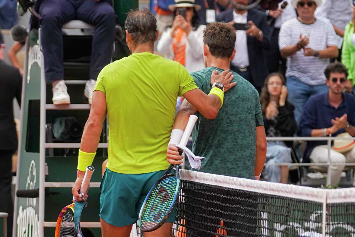 Spain's Rafael Nadal, left, comforts Norway's Casper Ruud after winning the final match in three sets, 6-3, 6-3, 6-0, at the French Open tennis tournament in Roland Garros stadium in Paris, France, Sunday, June 5, 2022. (AP Photo/Michel Euler)