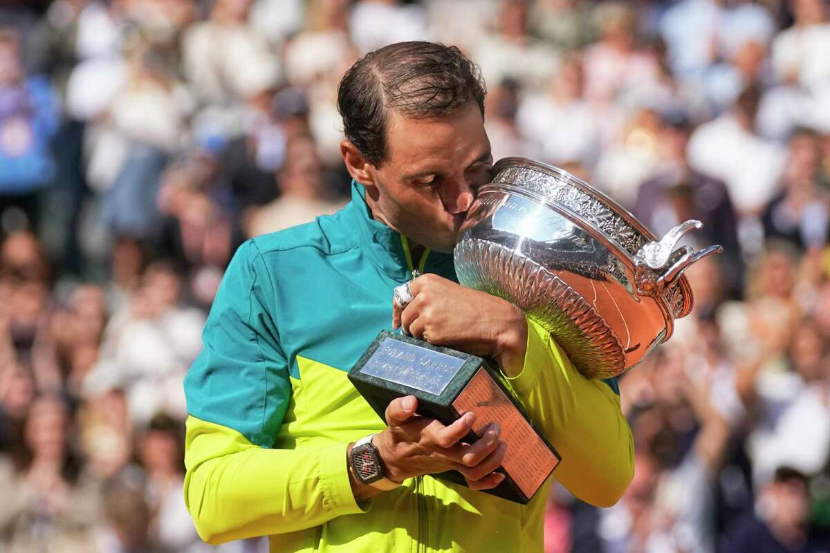 Spain's Rafael Nadal kisses the trophy after winning the final match against Norway's Casper Ruud in three sets, 6-3, 6-3, 6-0, at the French Open tennis tournament in Roland Garros stadium in Paris, France, Sunday, June 5, 2022. (AP Photo/Michel Euler)