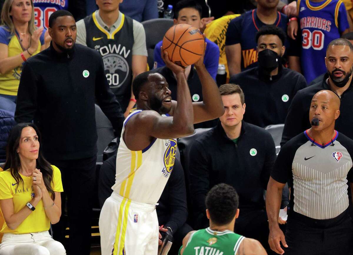 Aaron Miles, upper left, watches Draymond Green (23) shoot a three point shot during Game 1 of the NBA Finals between the Golden State Warriors and the Boston Celtics at Chase Center in San Francisco, Calif., on Thursday, June 2, 2022. Miles was a Warriors assistant coach, and is now with the Boston Celtics.