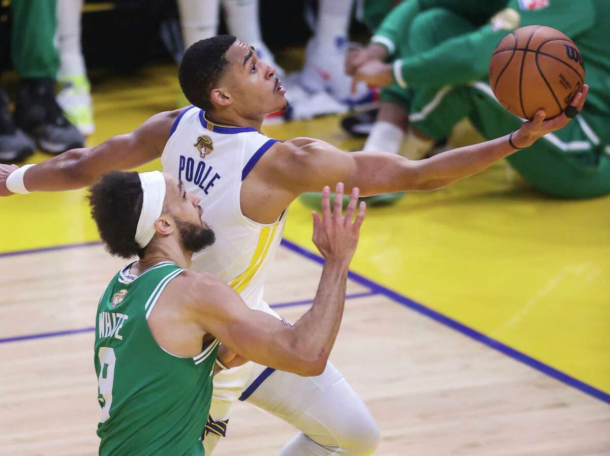Golden State Warriors' Jordan Poole, 3, gets past Boston Celtics' Derrick White, 9, during the second quarter of the NBA Finals at Chase Center in San Francisco, Calif., on Sunday, June 5, 2022.