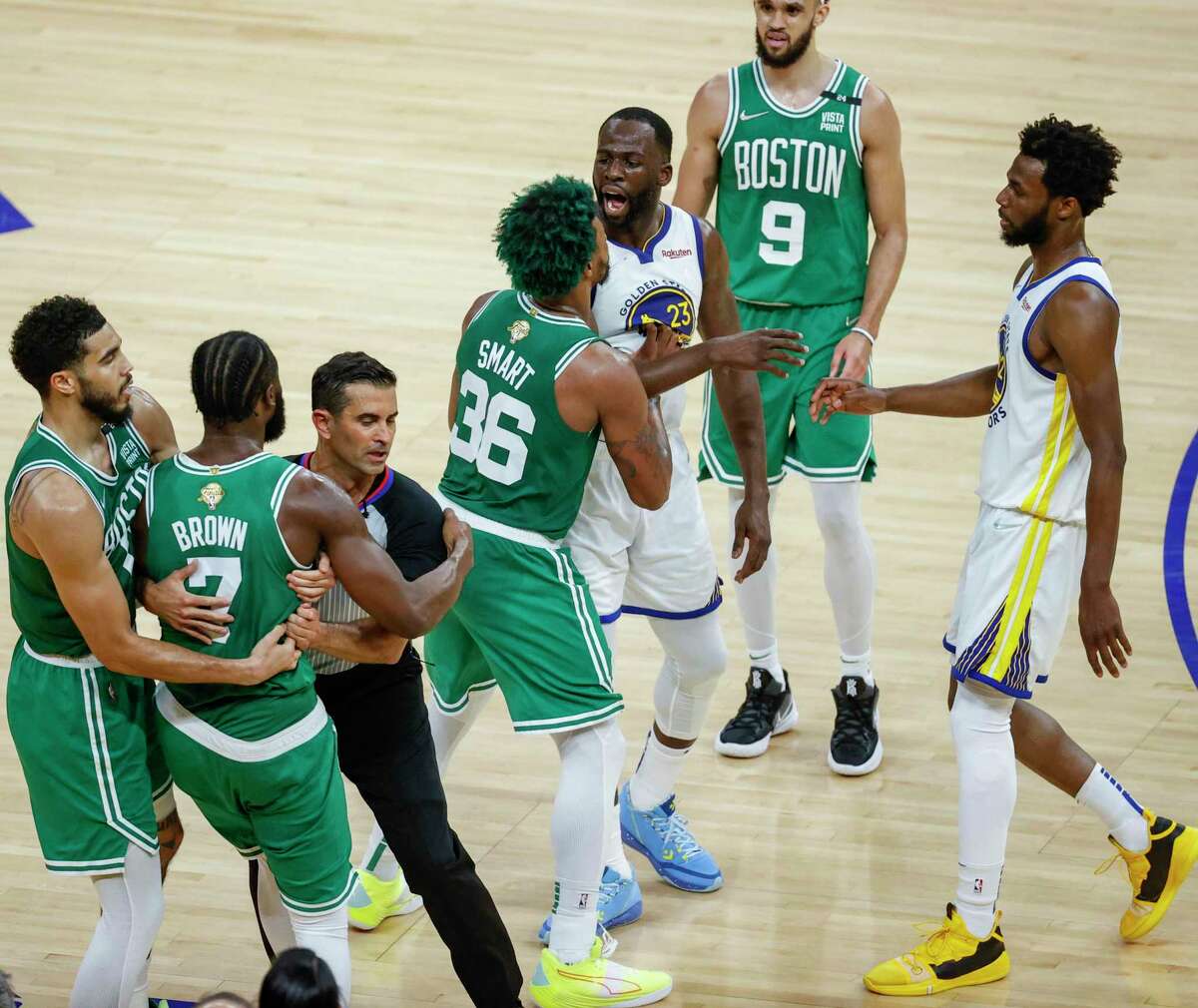 Golden State Warriors' Draymond Green, 23, shares words with Boston Celtics' Jaylen Brown, 7, during the second quarter of the NBA Finals at Chase Center in San Francisco, Calif., on Sunday, June 5, 2022.