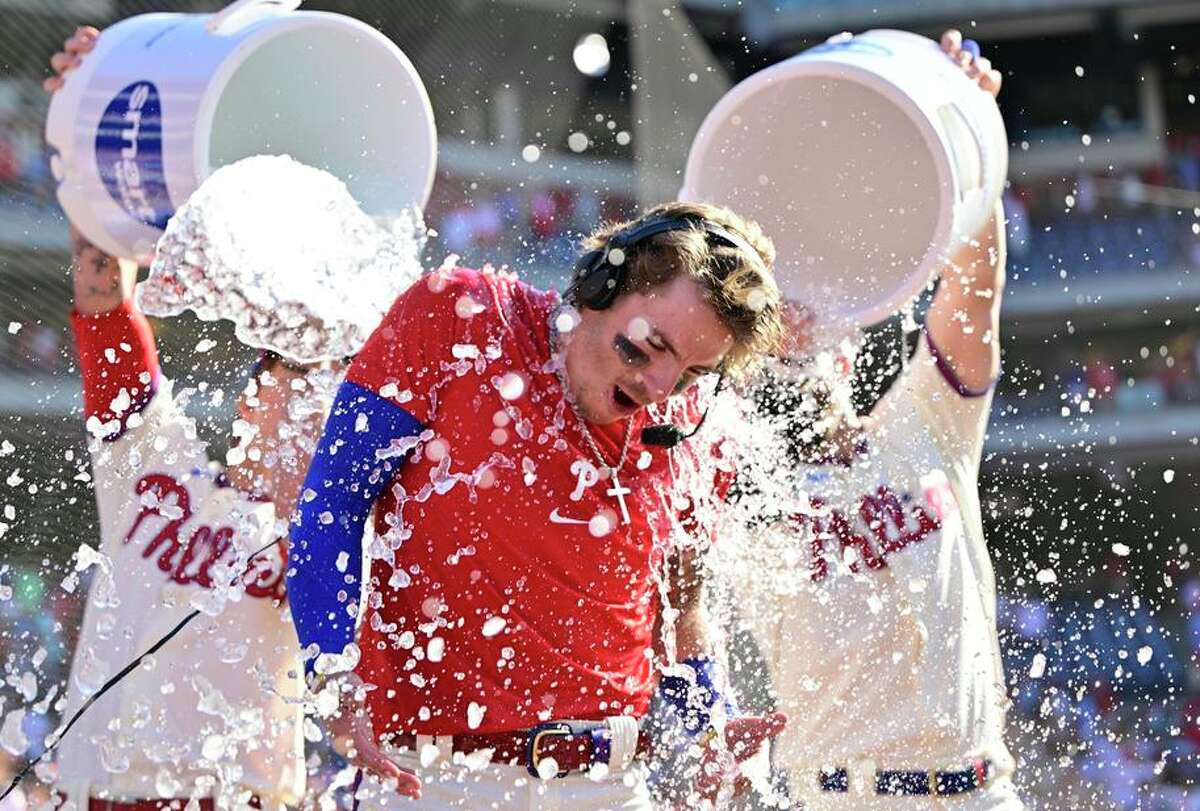 The Phillies’ Bryson Stott is doused by teammates after hitting a walk-off three-run home run in the ninth to beat the Angels.