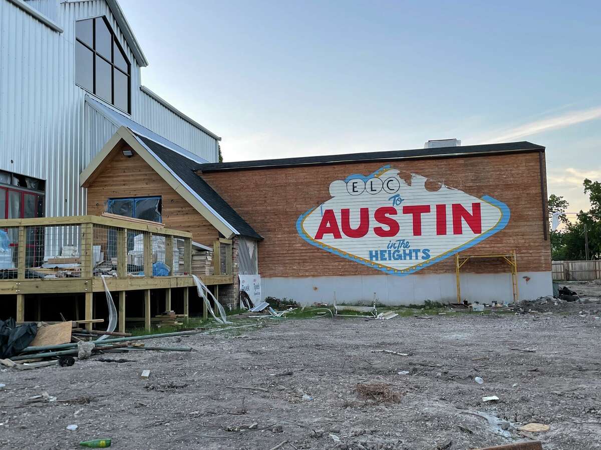 A "Welcome to Austin in the Heights" mural is being painted on the outside of a new bar called Austin's coming to Houston.