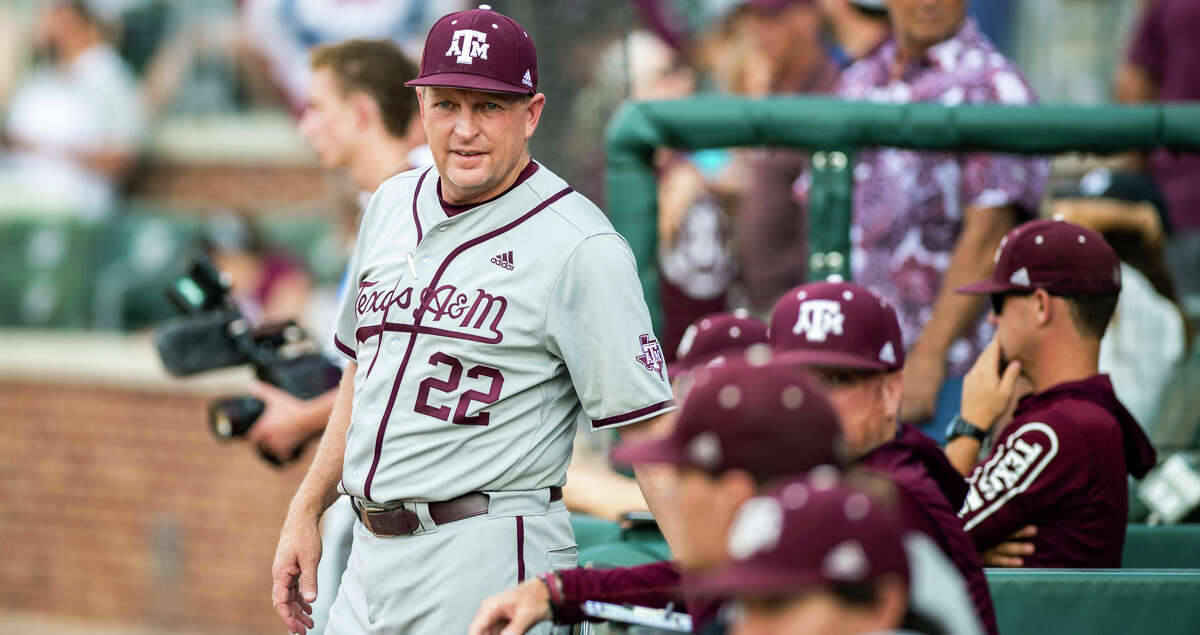 Texas A&M baseball coach Jim Schlossnagle speaks with his staff before they face TCU in an NCAA college baseball tournament regional game Sunday, June 5, 2022, in College Station, Texas. (Meredith Seaver/College Station Eagle via AP)
