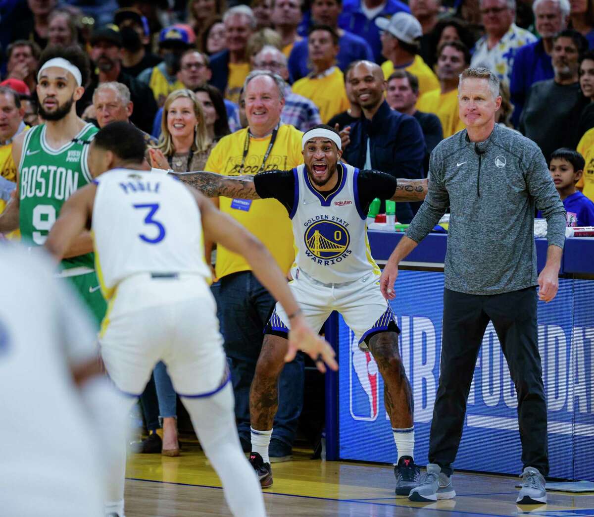 Golden State Warriors' Gary Payton II, 0, and Steve Kerr react to the action during the third quarter of the NBA Finals at Chase Center in San Francisco, Calif., on Sunday, June 5, 2022.