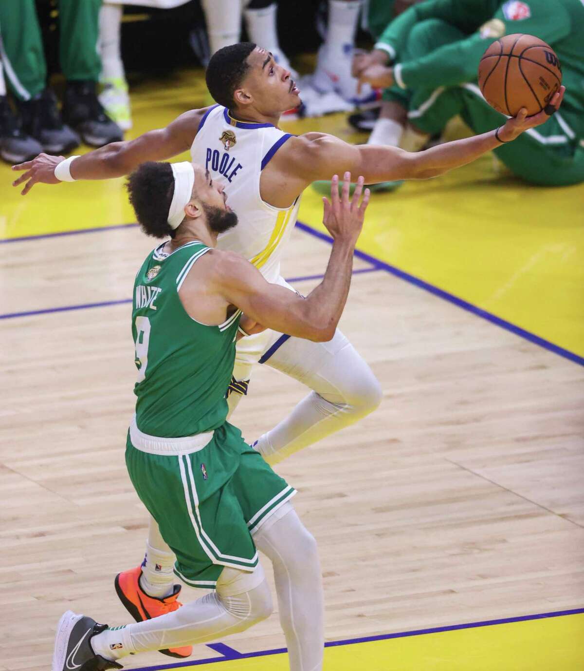 Golden State Warriors' Jordan Poole, 3, gets past Boston Celtics' Derrick White, 9, during the second quarter of the NBA Finals at Chase Center in San Francisco, Calif., on Sunday, June 5, 2022.