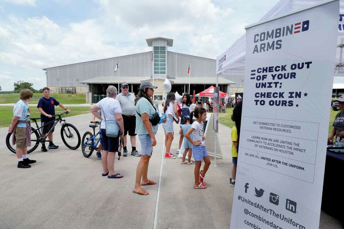 Attendees check in at the Combined Arms booth at the entrance to the second annual VetFest held at the Montgomery County Fairgrounds on Saturday in Conroe.