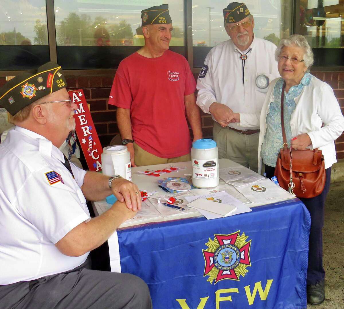 Chuck Larkins, Ed Masotta, and Bill Savastano, Branford VFW 12106 members and veterans of the Vietnam War, with Jeanne Prota of Branford.