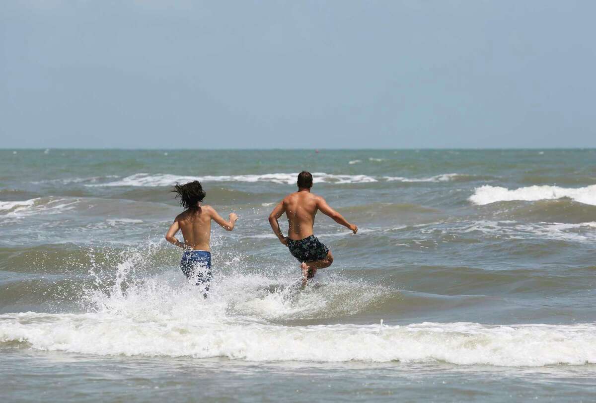 People enjoy a summer day on Stewart Beach on Friday, June 1, 2018, in Galveston. The blue water off Galveston over the past weekend has been driving a surge in tourism to Galveston.