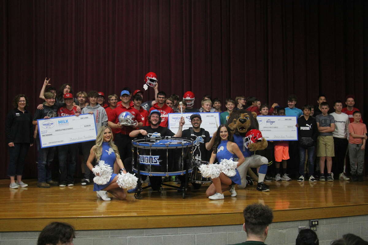 The Lions drum-line, cheerleaders and Caseville students all on stage with the grant checks.