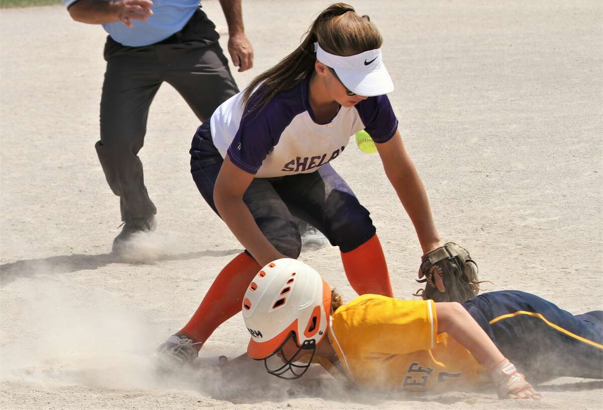 Manistee catcher Addy Witkowski slides back to third base after being caught in a rundown against Shelby on June 4 at Mason County Central high school.