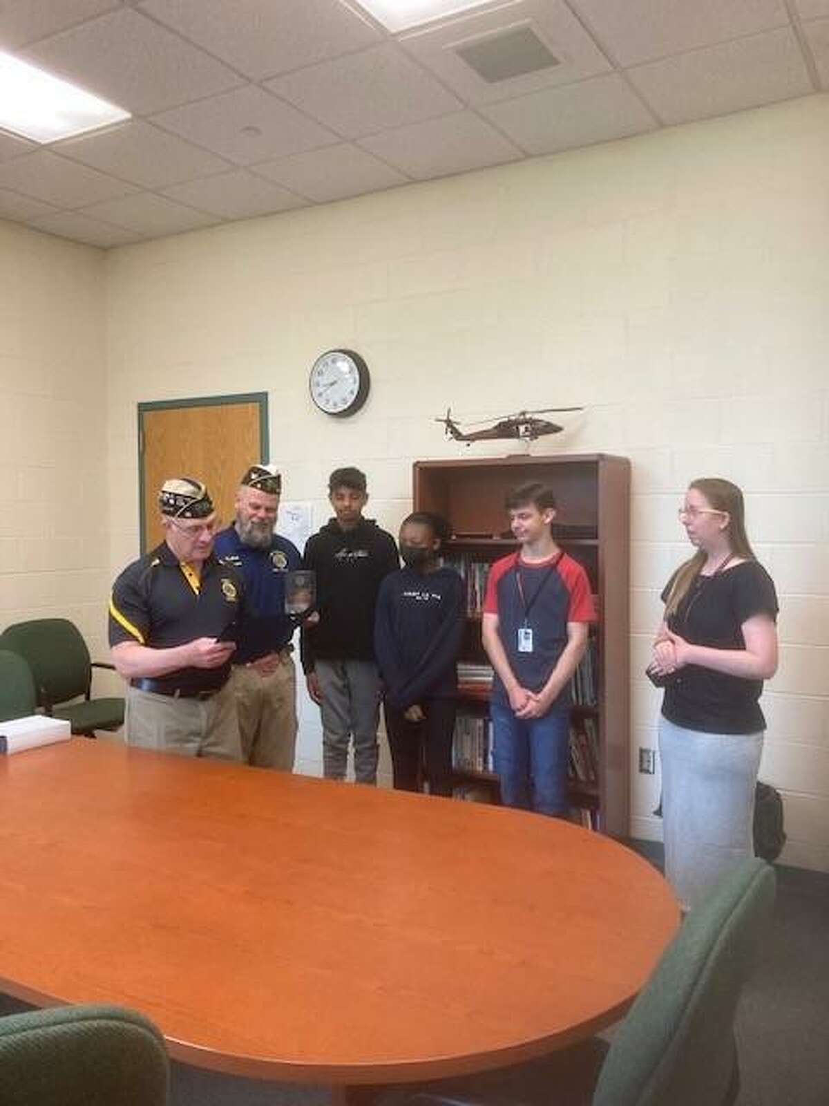 Sutter-Terlizzi American Legion Post 16 Adjutant Milt Harrigan presents Katelyn Botsford Tucker, The American Legion Department of Connecticut, Community Americanism Award. In the background are Mike Kellett, American Legion Department of Connecticut Executive Committeeman, as well as SIS Oratorical Contest finalists Joey Cummings, Krishiv Patel and Kailey Hill.