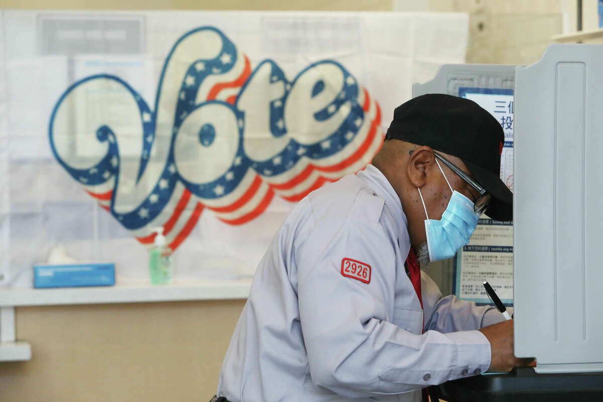 Larry McKinney, fills in his ballot in a booth at the polling place at Boba Guys on Fillmore Street on Tuesday, November 3, 2020 in San Francisco.