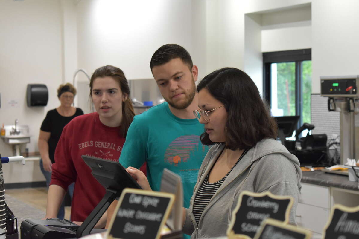 Ebels General Store held a soft opening for the new coffee shop and clothing store, an expansion of the existing Ebels General Store in Reed City. Above, Chase DeMott helps his coworkers with an order.