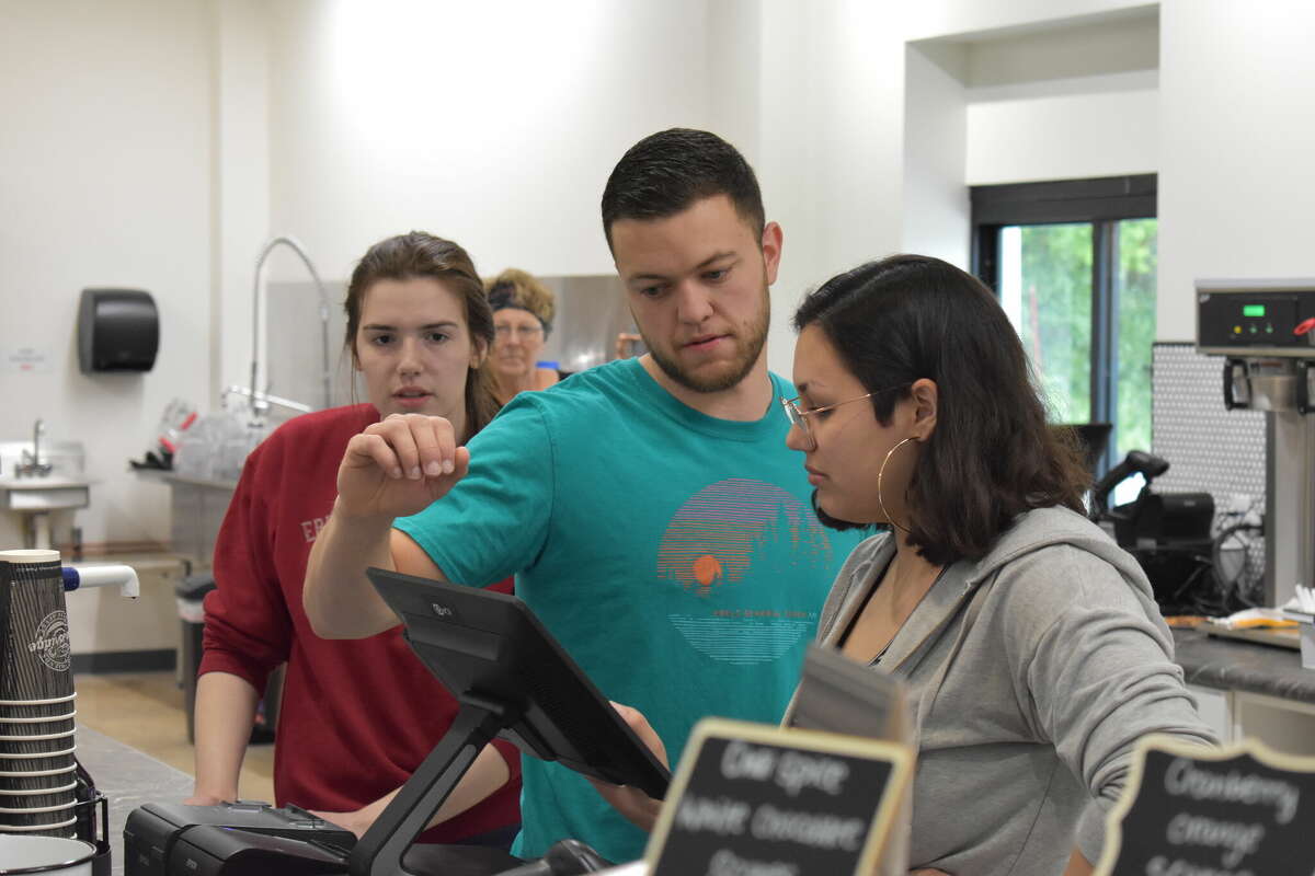 Ebels General Store held a soft opening for the new coffee shop and clothing store, an expansion of the existing Ebels General Store in Reed City. Above, Chase DeMott helps his coworkers with an order.