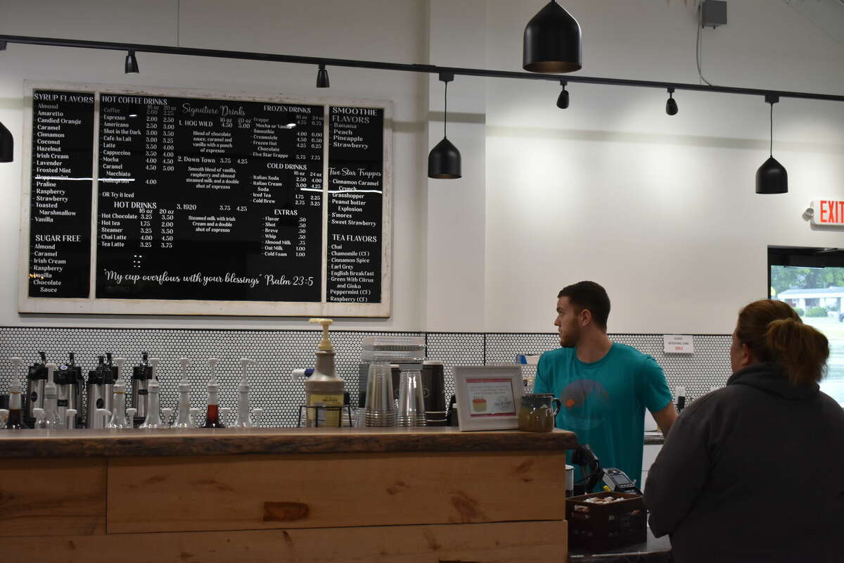 Ebels General Store held a soft opening for the new coffee shop and clothing store, an expansion of the existing Ebels General Store in Reed City. Above, Chase DeMott helps a customer with the menu.