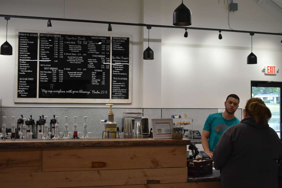 Ebels General Store held a soft opening for the new coffee shop and clothing store, an expansion of the existing Ebels General Store in Reed City. Above, Chase DeMott helps a customer with the menu.