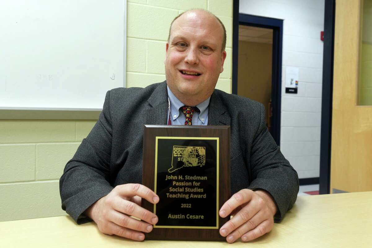 Teacher Austin Cesare poses at Foran High School, in Milford, Conn. June 6, 2022. Cesare has received the 2022 John Stedman Passion for the Social Studies Teaching Award by the Connecticut Council for the Social Studies.
