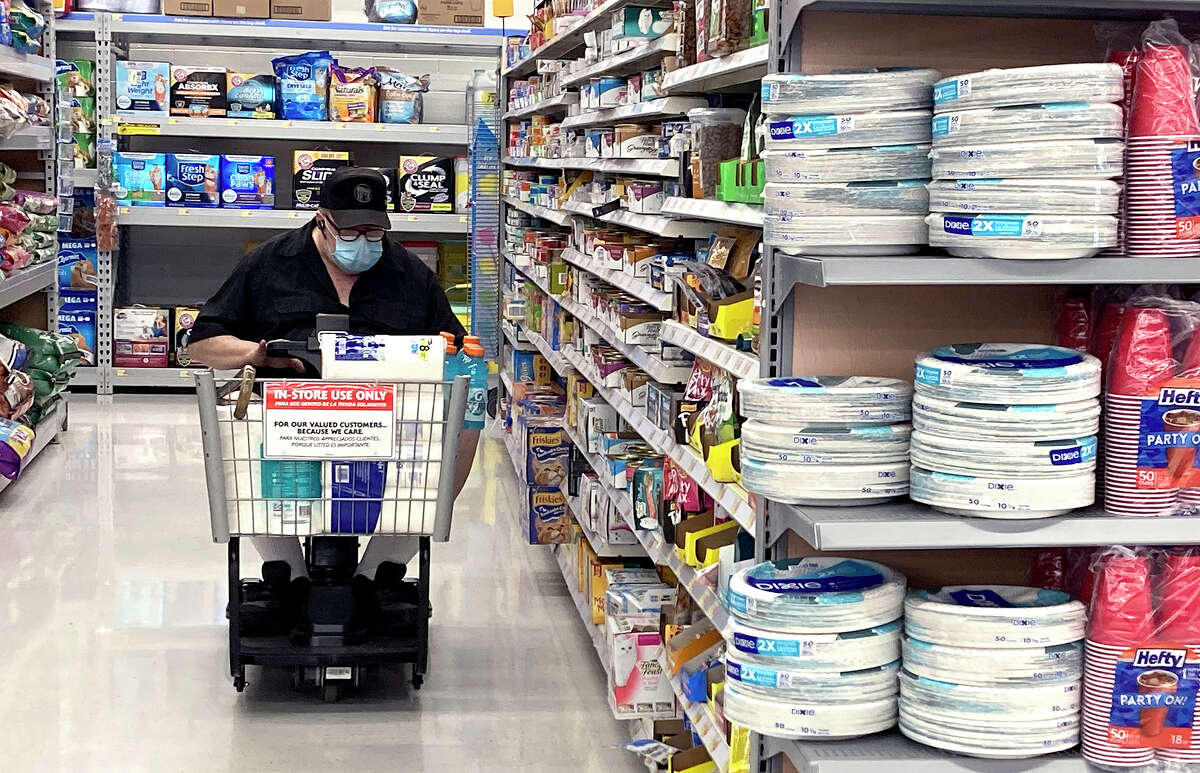 A shopper wearing a protective mask rides a motorized cart at a grocery store. Sangamon and Menard counties now are among those in Illinois where people are being urged to wear masks when indoors in public settings because of the increase of COVID-19 cases.