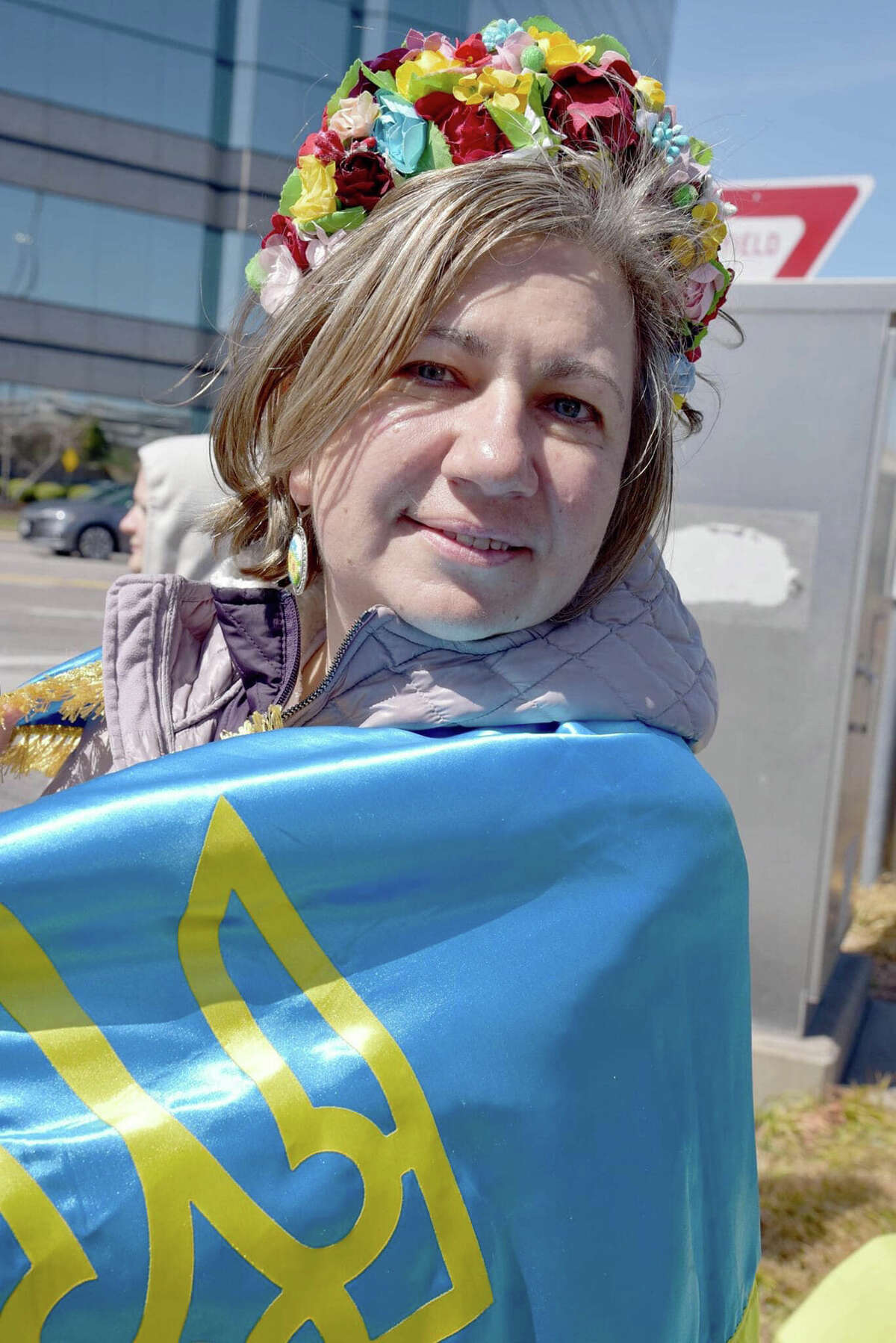 Tetiana Safronova of Ballwin, Missouri, is draped in the Ukrainian flag. She and her husband, Yuri Safronov, emigrated from Ukraine and now are working to provide the people of their native land with humanitarian aid.