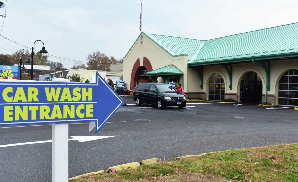 A worker towels down a vehicle in November 2016 at Splash Car Wash in Wilton, Conn.