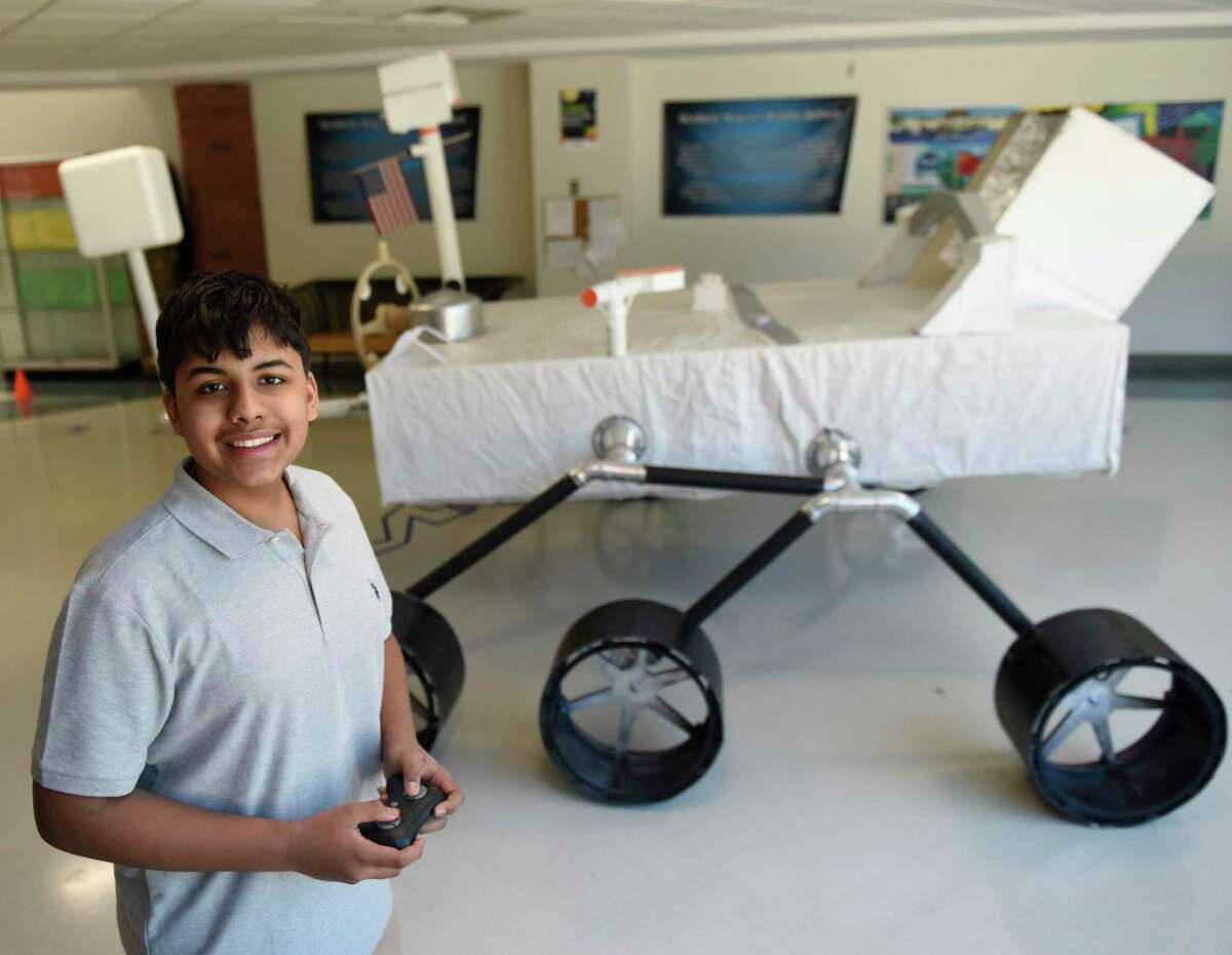 Eighth-grader Alexander Barker poses with the full scale Mars Perseverance Rover he built as part of his exhibition project at Scofield Magnet Middle School in Stamford, Conn. Monday, June 6, 2022. Scofield eighth-graders recently presented their long-term exhibition projects, ranging across a wide variety of STEM topics.