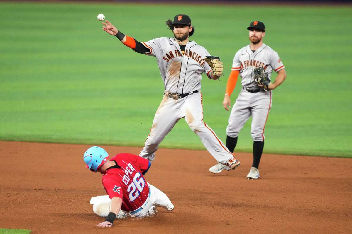 MIAMI, FLORIDA - JUNE 04: Brandon Crawford #35 of the San Francisco Giants throws towards firs while turning a double play in the fourth inning against the Miami Marlins at loanDepot park on June 04, 2022 in Miami, Florida. (Photo by Eric Espada/Getty Images)