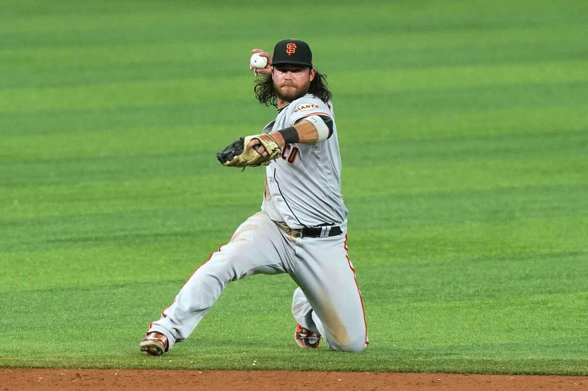 San Francisco Giants shortstop Brandon Crawford (35) catches a hit by Miami Marlins Jesus Aguilar during the ninth inning of a baseball game, Saturday, June 4, 2022, in Miami. (AP Photo/Marta Lavandier)