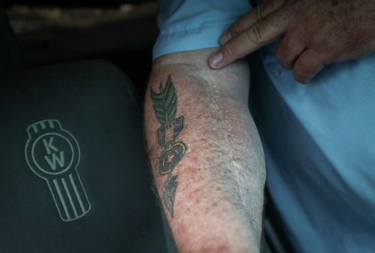 John Barnes talks about his tattoo and surgical scars Tuesday, May 24, 2022, at a truck yard in Pasadena. Barnes is a former police officer who was injured in 2018 during a mass shooting at Santa Fe High School.