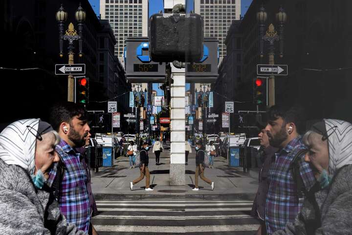 Pedestrians are seen alongside their reflections in windows along Sutter and Kearny streets.