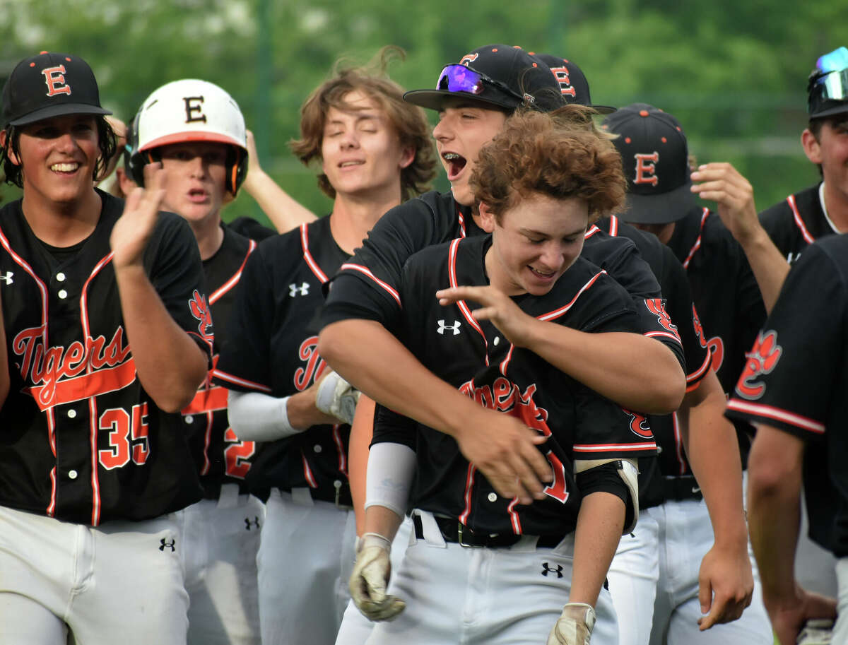 Edwardsville's Cole Funkhouser is mobbed by teammates after his walk-off hit against Plainfield North in the Class 4A Illinois Wesleyan Super-Sectional at Jack Horenberger in Bloomington.