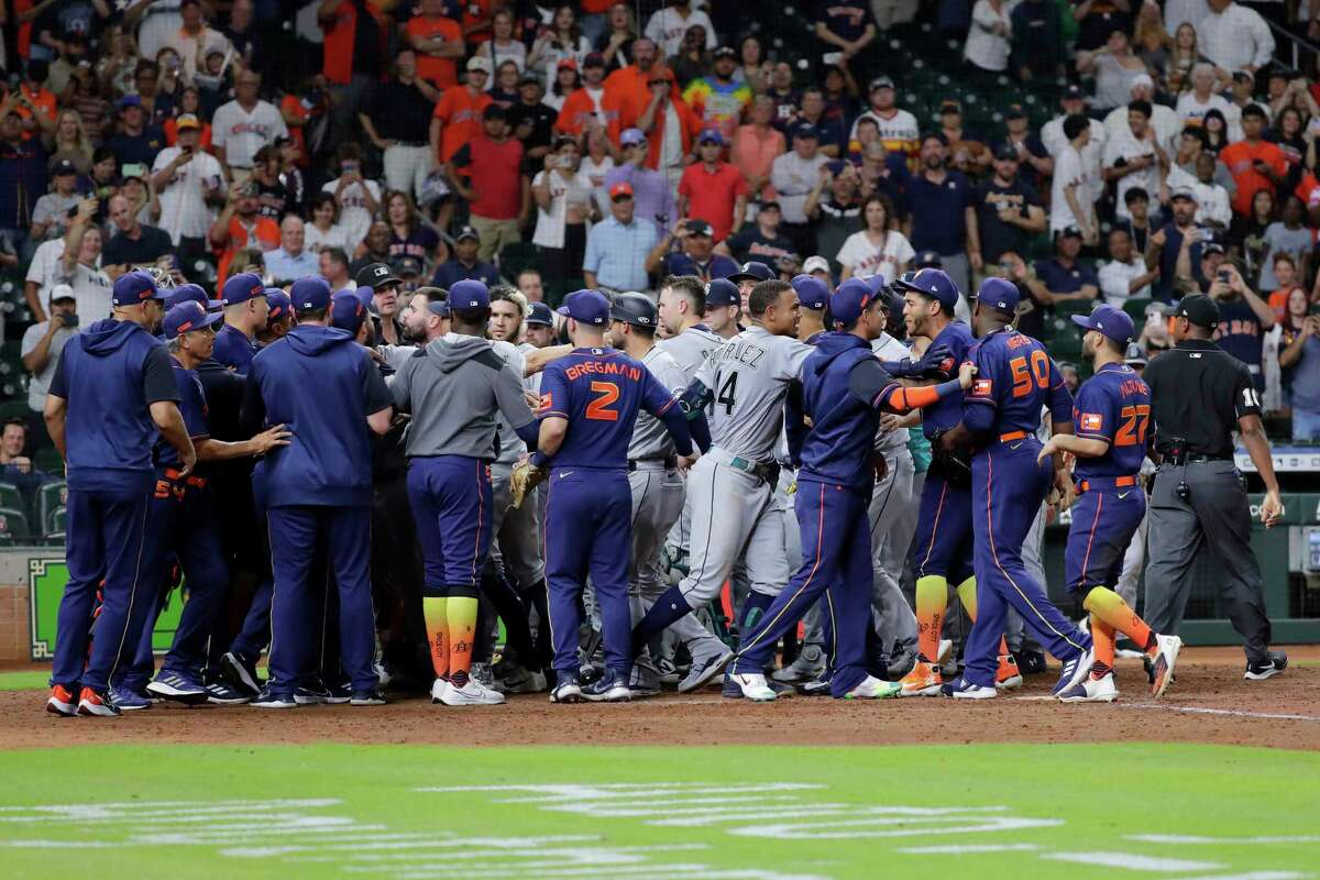 Both dugouts empty and umpires try to keep order after Seattle Mariners batter Ty France was hit by a pitch from Houston Astros relief pitcher Hector Neris during the ninth inning of a baseball game Monday, June 6, 2022, in Houston. (AP Photo/Michael Wyke)