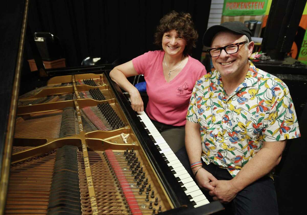 Piano technician Gina Bonfietti, left, and Pantochino Co-producer Bert Bernardi, with the theater company's newly donated piano at the studio in Milford, Conn. on Friday, June 3, 2022. Members of the Piano Technician's Guild are getting together for a day of work to refurbish the piano.