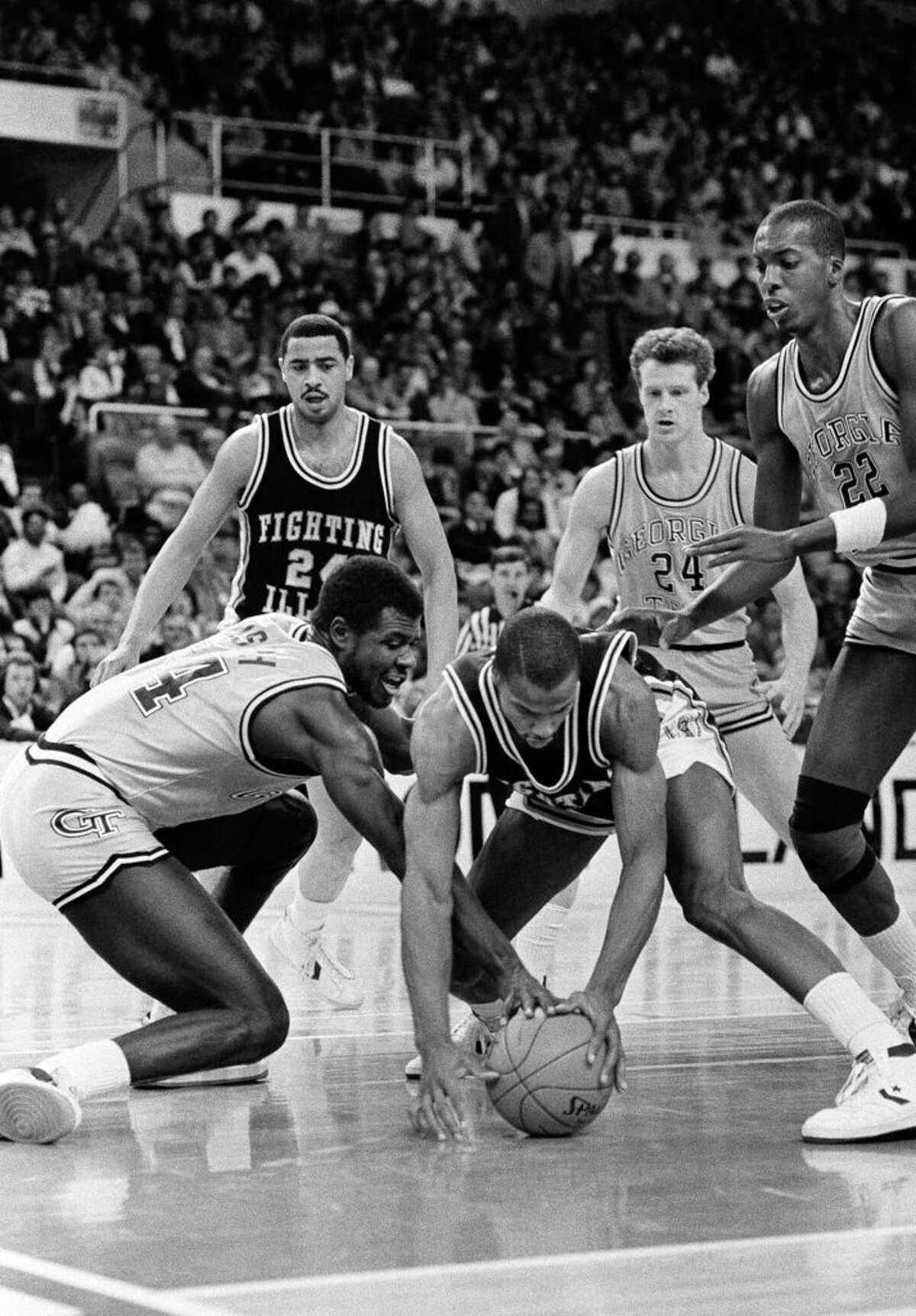 Yvon Joseph of Georgia Tech, left, tangles with Ken Norman of the Fighting Illini for a loose ball on the floor during first period action in NCAA East Regional semi-finals at Providence, R.I., March 21, 1985. 
