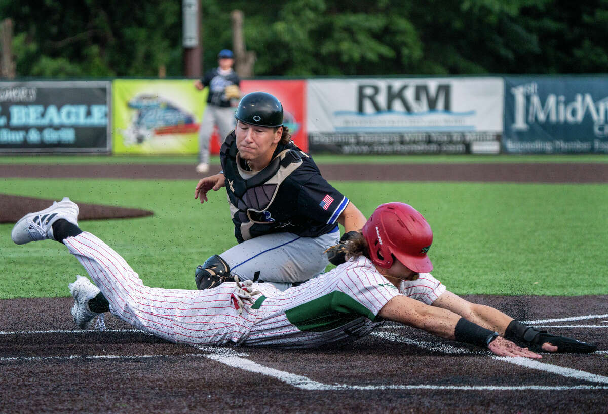 Alton River Dragons third baseman Kurtis Reid scores on a close play at the plate just under the tag of Rex Baseball catcher Will Egger on a base hit to right field in the bottom of the fourth inning Monday by Ben Gallaher. 