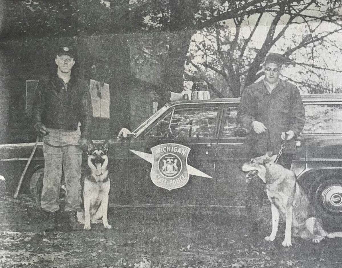 Bay City State Police Trooper Raymond Brotebeck, left, and Auburn Police Chief Thomas Gillman with their dogs at the end of a weekly dog refresher course. December 1968
