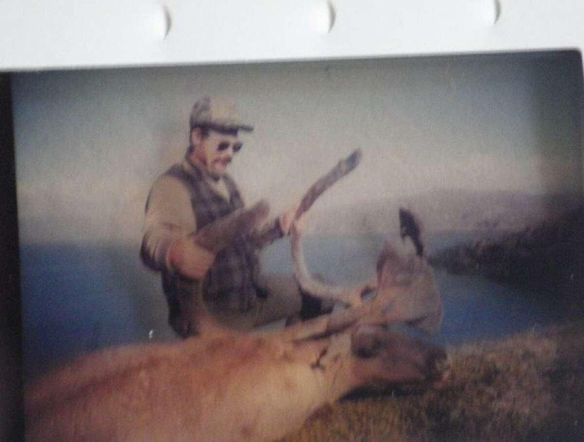 Tom Lounsbury is pictured with the caribou bull that he arrowed in the Arctic 30 years ago. The downwind scent of the kill, as well as the skinning and quartering of it,would attract an incoming polar bear. Fortunately, the tide came in, enough to allow for departure in a canoe before the bear's arrival. 