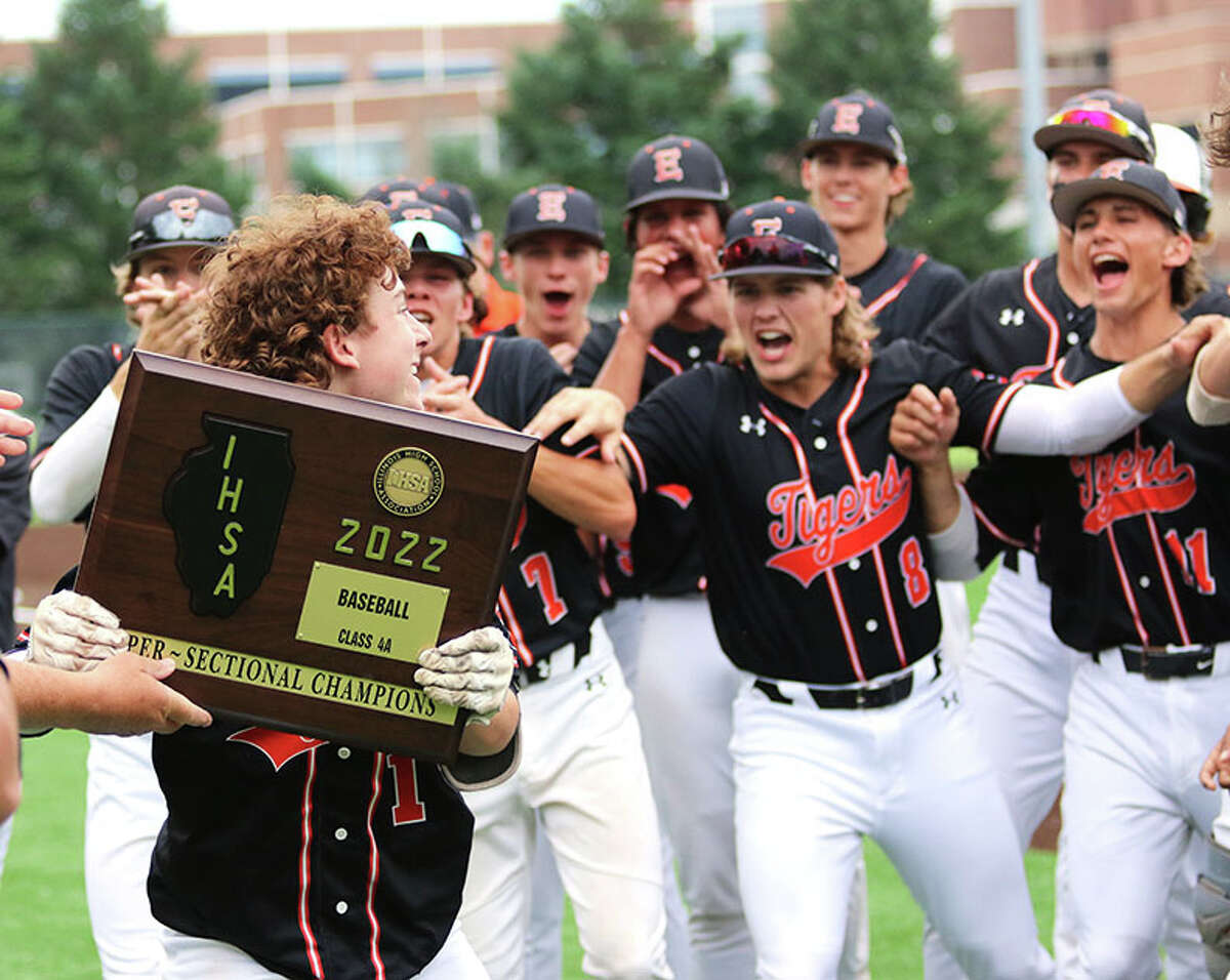 Edwardsville's Cole Funkhouser is handed the Class 4A super-sectional plaque and turns to take it to teammates after beating Plainfield North on Monday in the Bloomington Class 4A Super-Sectional.